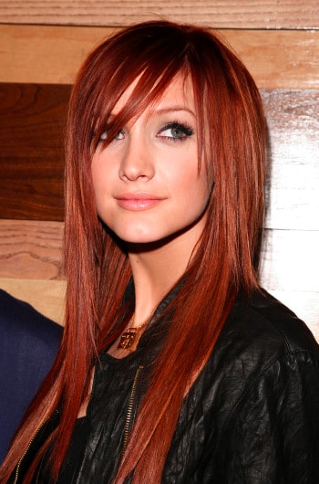 Sleek and straight in a rich red color with a long side-swept fringe, 